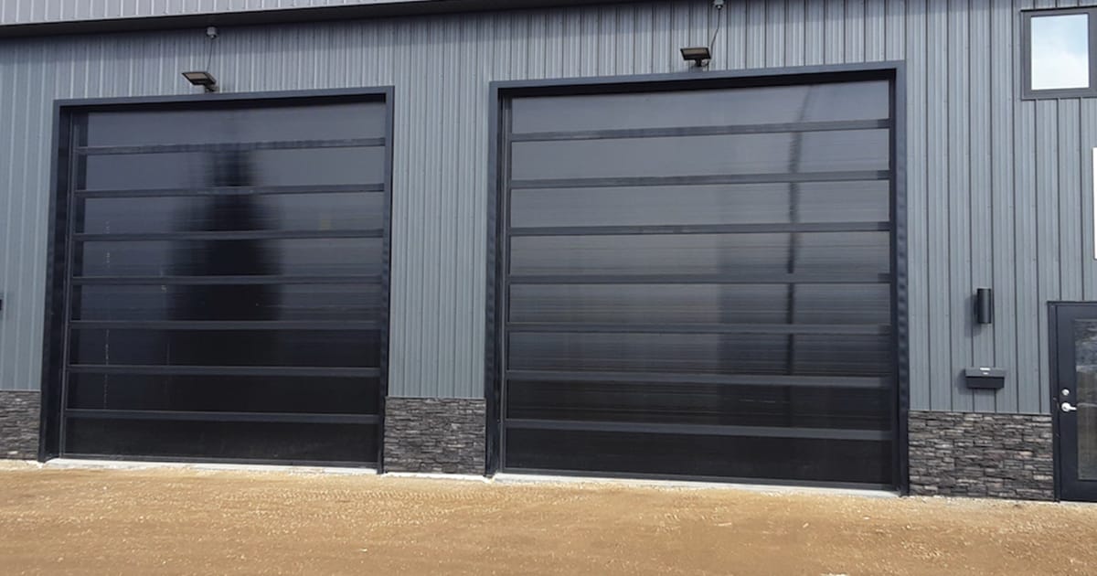 luxurious full glass overhead gargage doors on a nice home