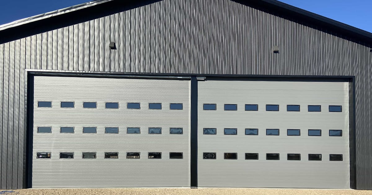 luxurious full glass overhead gargage doors on a nice home