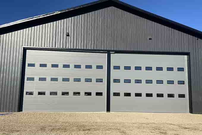 luxurious full glass overhead gargage doors on a nice home