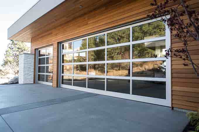 luxurious full glass overhead gargage doors on a nice home