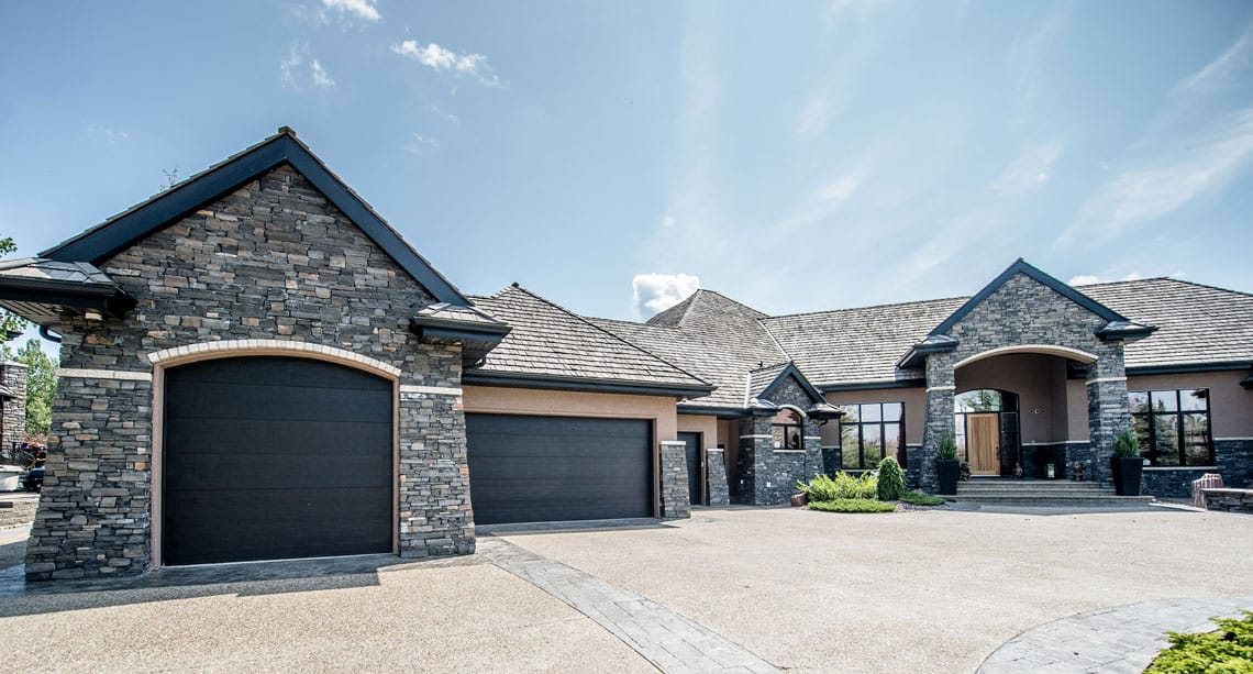 luxurious full glass overhead gargage doors on a nice home